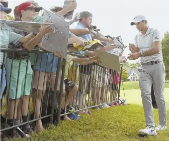  ?? AP PHOTO ?? WRITE STUFF: Jason Day signs autographs at TPC River Highlands yesterday.