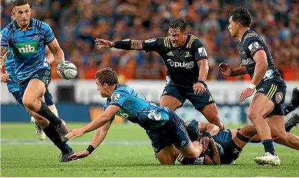  ?? PHOTO: GETTY IMAGES ?? Sonny Bill Williams, left, charges on to the ball for the Blues against the Highlander­s in the first full round of Super Rugby last weekend.