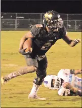  ?? Kevin Myrick / ?? Markus Smith causes a defender to miss as he runs toward the goal line against South Atlanta.