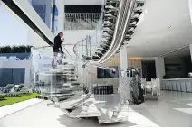  ??  ?? Developer Bruce Makowsky shows off the handcrafte­d steel staircase at the glorious mansion he built.