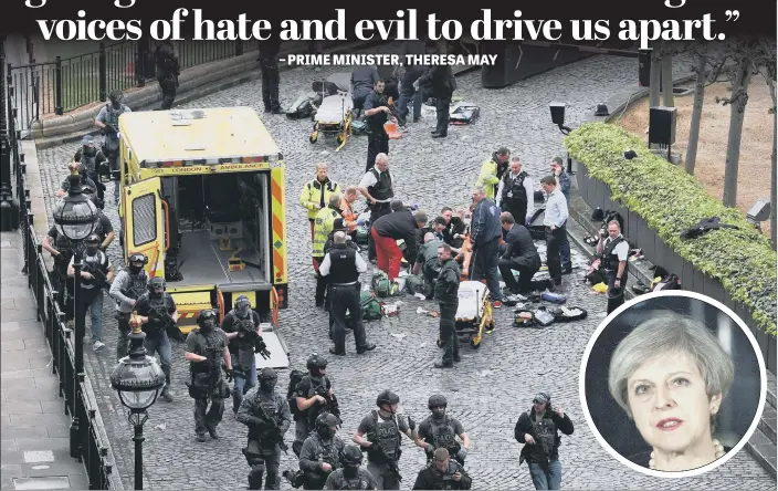  ?? PICTURES:PA. ?? SCENE OF HORROR: Armed police on alert as medics attend to a man on the floor and a police officer outside the Palace of Westminste­r after yesterday’s terror strike; inset, Prime Minister Theresa May.