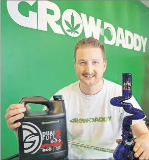  ?? JIM DAY/THE GUARDIAN ?? Chris Furlong displays some of the products in his new store in Stratford. The store, called GrowDaddy, sells products to help grow – and to consume – marijuana.