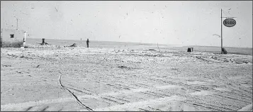  ?? Photo by Richard Mason ?? Gasoline is pumped from an oil drum at an Esso gas station 150 miles into the Libyan desert.