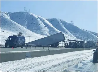  ?? MAYRA ORTIZ/Valley Press ?? A semi truck slid off the 14 Freeway early Friday morning. Traffic was backed up in the northbound lanes as the vehicle was cleared, but a Sigalert for the incident lasted well into Friday evening.