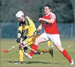  ?? Photo: Stephen Lawson ?? Inveraray scorer Lewis Montgomery nips in ahead of Jason McLeod.