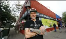  ?? AP PHOTO/DAVID ZALUBOWSKI ?? In this Sunday photo, Jim Norris poses for a photo outside of his informatio­n cafe called Mutiny in south Denver. Norris is hoping to license his storefront as one of the nation’s first legal marijuana clubs.