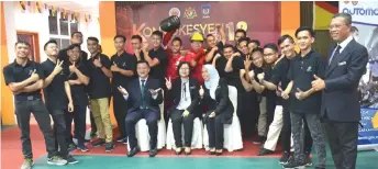  ??  ?? Ramona (seated centre) together with Dr Wasitah, on her left, and Lamat, pose for a group photo with students and staff of IKBN Miri at the 12th IKBN Miri convocatio­n ceremony.