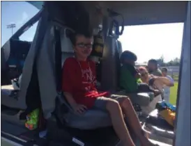  ?? KEVIN MARTIN — THE MORNING JOURNAL ?? Six-year-old Elijah Knighten, a first-grade student at Powers Elementary School in Amherst, of sits inside of a MedEvac helicopter on Aug. 1 at Clearview High School’s Tom Hoch Field located at 4700 Broadway Ave. in Sheffield Township for National...