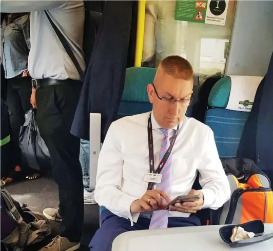  ??  ?? Nice and comfy: Train boss Mark Boon finds there’s plenty of room for himself and his bag in the first-class carriage