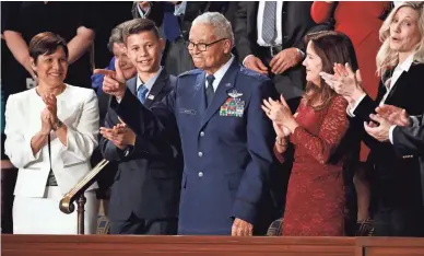  ??  ?? Tuskegee Airman Charles McGee, 100, and his great-grandson Iain Lanphier stand as McGee is applauded at the State of the Union address on Tuesday.