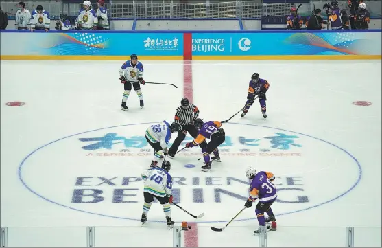  ?? WEI XIAOHAO / CHINA DAILY ?? Hockey players go to battle at Beijing’s National Indoor Stadium, which has been transforme­d from a 2008 Summer Olympics facility into a 2022 Winter Games venue. The ‘Experience Beijing’ test program was the first competitiv­e action on the stadium’s newly produced ice surface.