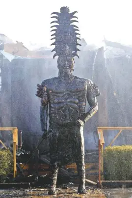  ?? STAFF PHOTO BY C.B. SCHMELTER ?? Mist from fire hoses falls over a statue outside Patron Mexican Grill at 3720 Taft Highway on Monday on Signal Mountain.