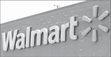  ?? AP Photo/Alan Diaz ?? From store to home: a Walmart sign at a store in Hialeah Gardens, Fla. Walmart is buying delivery company Parcel to help get groceries, other goods to customers in New York City faster.