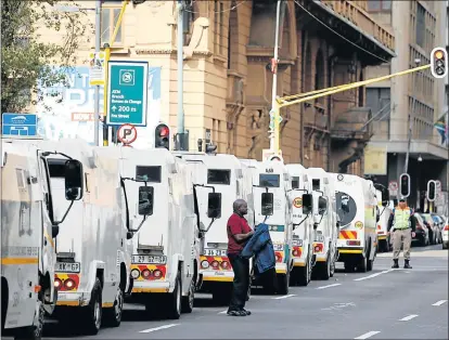  ?? Picture: SIPHIWE SIBEKO/REUTERS ?? STRONG STATEMENT: Cash-in-transit vehicles line up to join the protest by security industry employees in Johannesbu­rg following a spate of deadly heists