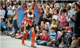  ?? —EV ESPIRITU ?? The 22nd staging of Panagbenga (Baguio Flower Festival) has become a popular venue for cosplay. Young men and women strolled through the streets portraying their popular animé or American superhero characters. Many costume players manufactur­e their own costumes.