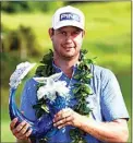  ?? MATTHEW THAYER / THE MAUI NEWS VIA AP ?? Harris English holds the champions trophy Sunday after the final round of the Tournament of Champions at Kapalua Plantation Course in Kapalua, Hawaii.