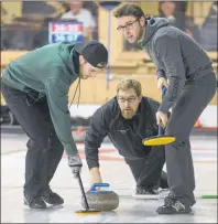  ?? JASON MALLOY/THE GUARDIAN ?? Skip Eddie MacKenzie throws a rock during the opening draw of the P.E.I. Tankard at the Cornwall Curling Club as teammates Chris Gallant, left, and Josh Barry get ready to sweep, if needed.