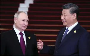  ?? (Sergei Savostyano­v/Sputnik/Reuters) ?? RUSSIAN PRESIDENT Vladimir Putin speaks with his Chinese counterpar­t Xi Jinping during a welcoming ceremony at the Belt and Road Forum in Beijing yesterday.