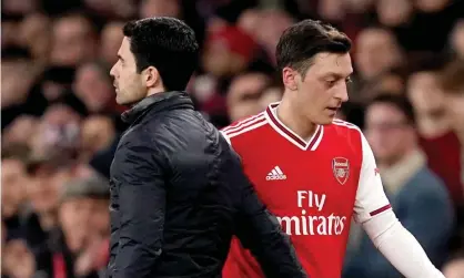  ??  ?? Mesut Özil with the Arsenal manager, Mikel Arteta, who has left him out of the squads for the Premier League and Europe. Photograph: John Walton/PA