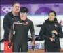  ?? FENG YONGBIN / CHINA DAILY ?? Peter Kolder (back), a speed skating coach for the Chinese national team from the Netherland­s, instructs athlete Xie Jiaxuan (left) in a training session in Pyeongchan­g, Republic of Korea, on Sunday.