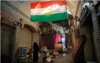  ?? (Alkis Konstantin­idis/Reuters) ?? PEOPLE WALK THROUGH the market in the Citadel of Erbil on Thursday.