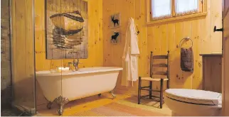  ??  ?? Country-chic styling isn’t lost in the main bathroom, which has a free-standing bathtub.