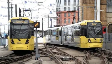  ?? CARL CHAMBERS. ?? Two Metrolink trams cross at Manchester Victoria on November 15 2016. Metrolink must make sure it is able to accommodat­e future demand and expansion plans, says David Holt.