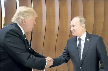  ?? STEFFEN KUGLER/THE ASSOCIATED PRESS ?? In this photo provided by the German government, U.S. President Donald Trump, left, shakes hand with Russian President Vladimir Putin before the first working session of the G20 summit in Hamburg, Germany.