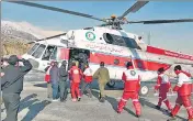  ??  ?? Rescue teams work to transport the bodies of mountainee­rs who died after a blizzard and avalanches hit the mountains in Iran.