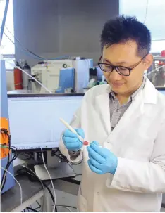  ??  ?? Scientist Jialing Zhang as he demonstrat­es using the MasSpec Pen to analyze a human tissue sample. Scientists are developing a highly experiment­al penlike probe to help surgeons better tell when it’s safe to stop cutting or if stray tumor cells still...