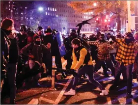  ?? REUTERS ?? Members of the far-right group Proud Boys clash with counter protesters, while alleging election fraud, in downtown Washington, US, on 12 December.