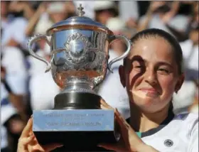  ?? MICHEL EULER — THE ASSOCIATED PRESS ?? Jelena Ostapenko holds the cup after defeating Simona Halep in women’s final at the French Open Saturday in Paris.