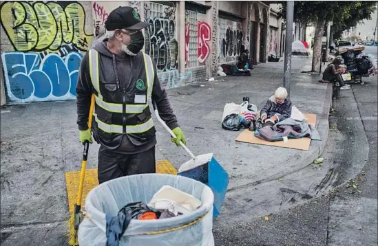  ?? Photograph­s by Francine Orr Los Angeles Times ?? URBAN ALCHEMY practition­er Marcus Pelham tidies up a skid row sidewalk in downtown L.A. “It’s dangerous out here, and it’s kind,” the former convict said.