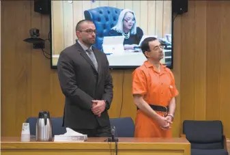  ?? Rena Laverty / AFP / Getty Images ?? Larry Nassar (right) listens to Judge Janice Cunningham (on screen) at his sentencing in Charlotte, Mich. More than 260 women and girls have reported being molested by Nassar.