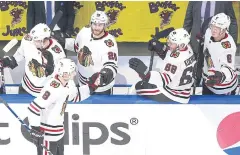  ?? AFP ?? The Blackhawks’ Dominik Kubalik is congratula­ted by teammates on the bench after he scored in the second period against the Oilers.