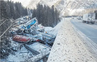  ?? JEFF MCINTOSH THE CANADIAN PRESS ?? The Canadian Pacific freight train fell more than 60 metres from a bridge near the Alberta-British Columbia boundary in a derailment that killed three crew members. Only 13 of the 112 grain cars that made up the train remained on the tracks.