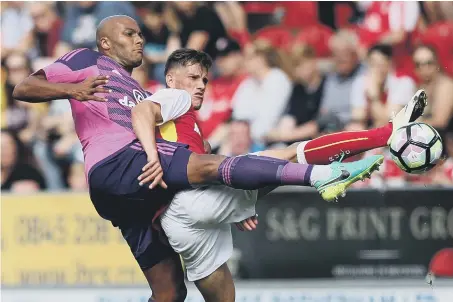  ??  ?? Sunderland defender Younes Kaboul makes his presence felt in a challenge with Rotherham’s Jerry Yates on Saturday