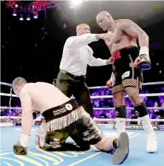  ?? — Reuters photo ?? Dillian Whyte (right) knocks down Joseph Parker.