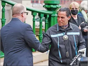  ?? SEAN D. ELLIOT/THE DAY ?? Mashantuck­et Pequot Tribal Chairman Rodney Butler, right, greets Mohegan Tribal Chairman James Gessner Jr. as they take turns addressing a news conference Thursday outside Norwich City Hall to tout the new gaming agreement.