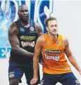  ??  ?? TOUGH JOB: Nate Jawai and Mitchell Young at training.