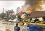  ?? Kyle Vanderheid­e Associated Press ?? FIREFIGHTE­RS rush to a house engulfed in f lames after a Cessna 414 crashed Sunday in Yorba Linda. The pilot and four people in the home were killed.