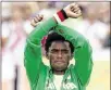  ?? ROBERT F. BUKATY / AP ?? Silver medalist Feyisa Lilesa of Ethiopia acknowledg­es applause during the men’s marathon award ceremony by displaying a symbol of antigovern­ment protests in his country.