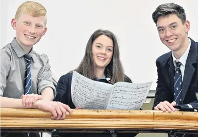  ?? PHOTO: LINDA ROBERTSON ?? In fine voice . . . New Zealand Secondary Schools Choir members Teddy Finney Waters (14), Elizabeth Purvis (16) and Nicholas Finnie (17) prepare for their first rehearsals with the national choir.