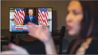  ?? Associated Press ?? ■ Natalie Abbas works at her “Command Post,” her dining room table, in Myersville, Md., as she watches Fox News broadcast President Donald Trump’s farewell address Tuesday.