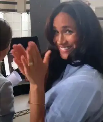  ??  ?? Excited: Meghan previews a photoshoot for her charity fashion line last night