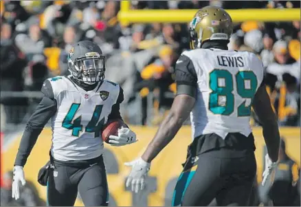  ?? Brett Carlsen Getty Images ?? A COUPLE OF FORMER UCLA stars, Myles Jack (44) and Marcedes Lewis, celebrate after Jack’s intercepti­on against Pittsburgh.