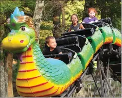  ??  ?? Youngsters enjoy a ride on the Dragon Wagon.