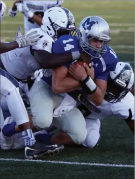  ?? RANDY MEYERS — THE MORNING JOURNAL ?? Midview quarterbac­k Dustin Crum is stopped by the Titans defense after a short gain during the first quarter on Aug. 26.