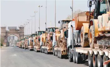  ?? — AFP ?? Vehicles belonging to the engineerin­g department of the Hashed al Shaabi paramilita­ry forces are pictured as they arrive in Basra on Saturday. Prime Minister Haider al Abadi, earlier in the week, announced a public works initiative­s for the city, hit by a wave of deadly protests.