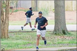  ?? (AP) ?? Runners take advantage of the 1-mile Parham Bridges walking track, March 23, 2020, in
Jackson, Miss.